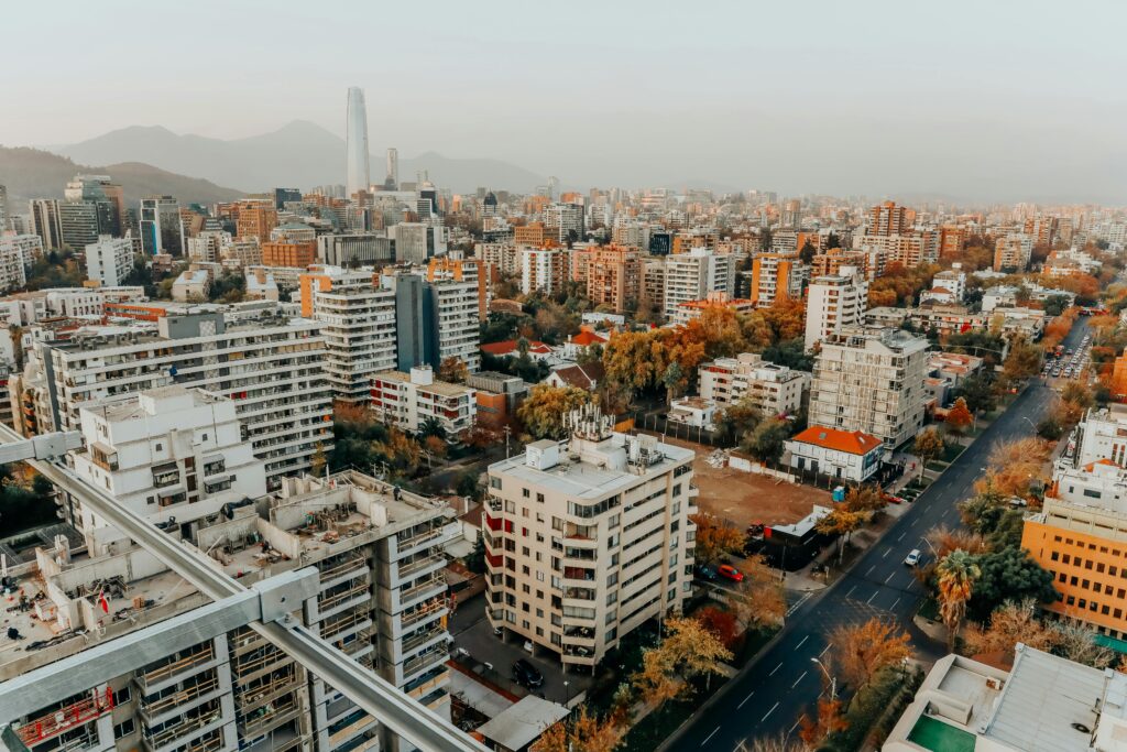 Aerial view of the vibrant Santiago cityscape during the day, showcasing modern architecture.