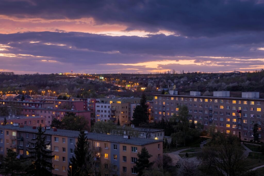 A scenic twilight view over residential buildings in Prague, Czechia, highlighting urban architecture.